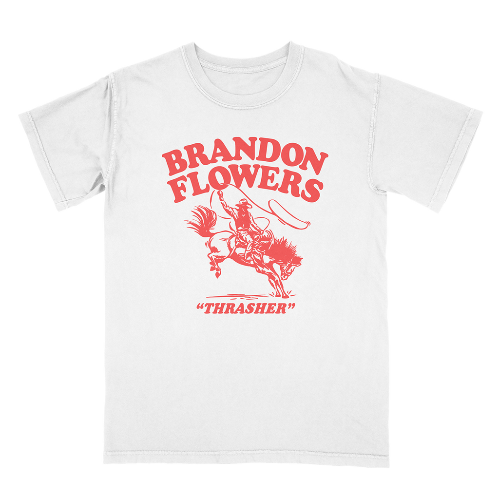 A white short-sleeve crewneck t-shirt featuring a red graphic print of a cowboy riding a bucking bronco, with the text 'BRANDON FLOWERS' and '"THRASHER"' printed below.