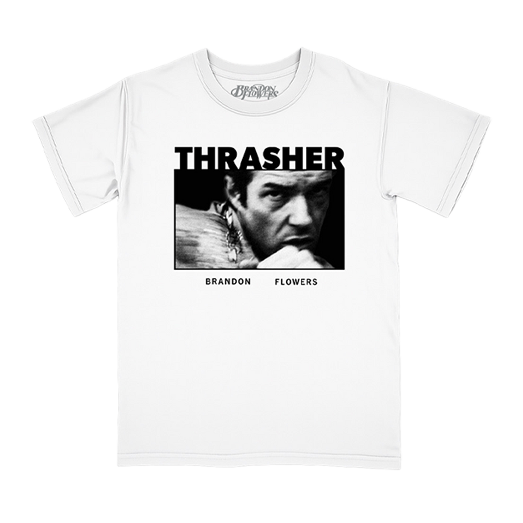 A white short-sleeve crewneck t-shirt featuring a black and white graphic print of a Brandon Flowers under the word 'THRASHER' and above 'BRANDON FLOWERS'.